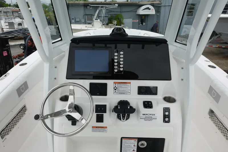 Yacht Photos Pics 2025 Sea Fox 268 Commander boat dashboard with steering wheel and navigation controls.