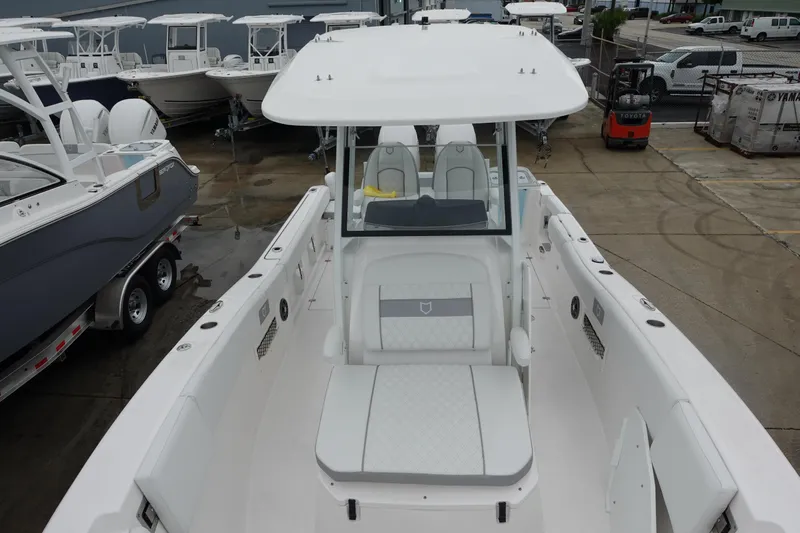  Yacht Photos Pics 2025 Sea Fox 268 Commander boat, white interior, docked with other boats in the background.