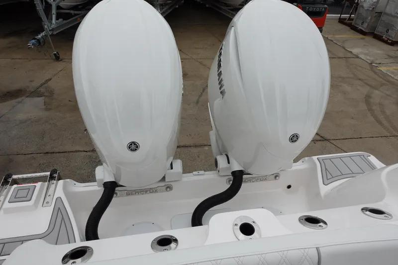  Yacht Photos Pics 2025 Sea Fox 268 Commander boat with dual outboard engines, docked on concrete surface.