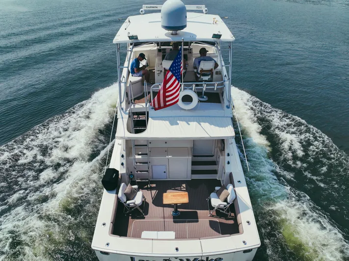 Lay A Wake Yacht Photos Pics Aerial view of 1990 Viking 53 Convertible yacht cruising with American flag.