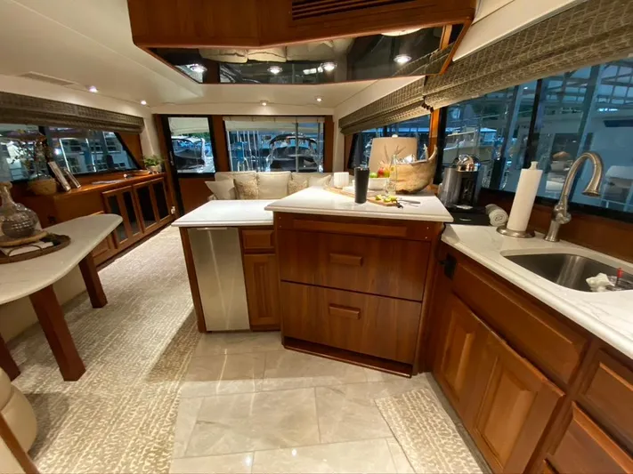 Lay A Wake Yacht Photos Pics Luxurious interior of a 1990 Viking 53 Convertible yacht with modern kitchen amenities.