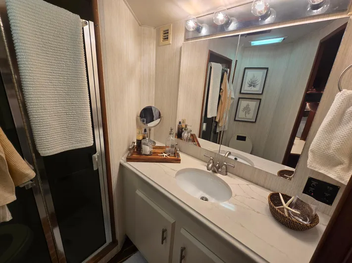 Lay A Wake Yacht Photos Pics Bathroom interior of a 1990 Viking 53 Convertible yacht with modern fixtures and decor.
