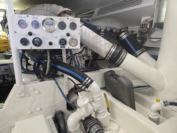 Lay A Wake Yacht Photos Pics Engine room of a 1990 Viking 53 Convertible boat, featuring gauges and piping.