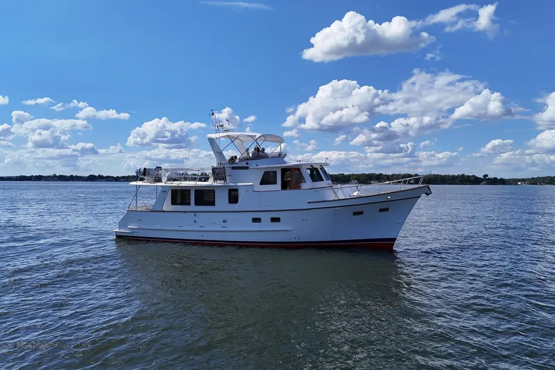 Marjorie Ann Yacht Photos Pics 2006 DeFever 52 Euro yacht on calm water under a blue sky with clouds.