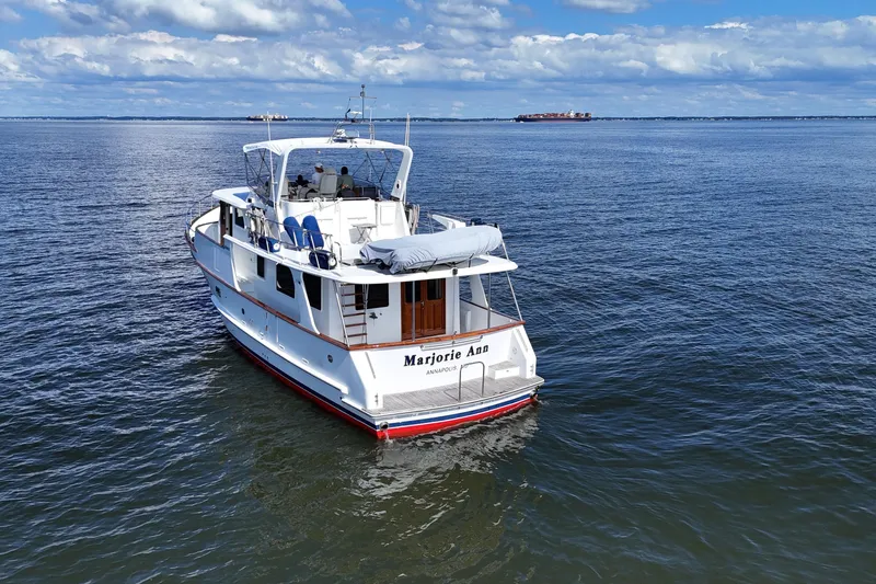 Marjorie Ann Yacht Photos Pics 2006 DeFever 52 Euro yacht cruising on open water under a partly cloudy sky.