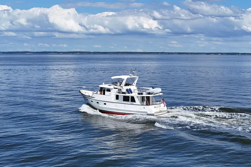 Marjorie Ann Yacht Photos Pics 2006 DeFever 52 Euro yacht cruising on open water under a partly cloudy sky.