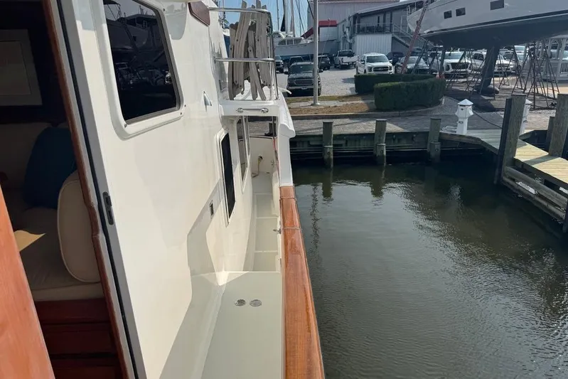 Marjorie Ann Yacht Photos Pics 2006 DeFever 52 Euro yacht docked at marina, side view with water reflection.