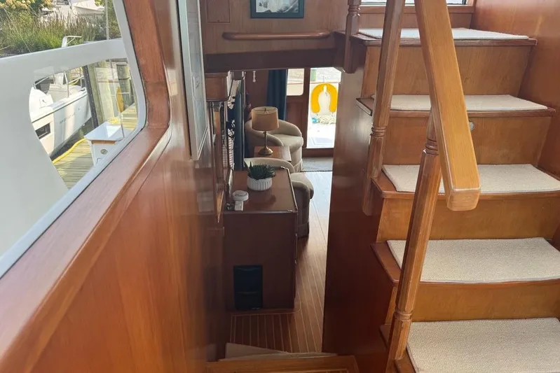 Marjorie Ann Yacht Photos Pics Interior of 2006 DeFever 52 Euro yacht with wooden stairs and cozy seating area.