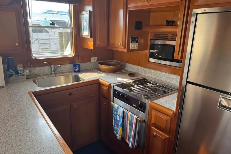 Marjorie Ann Yacht Photos Pics Galley kitchen in 2006 DeFever 52 Euro yacht with stainless steel appliances.