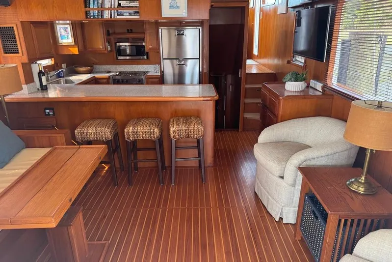 Marjorie Ann Yacht Photos Pics Luxurious 2006 DeFever 52 Euro yacht interior with modern kitchen and cozy seating area.