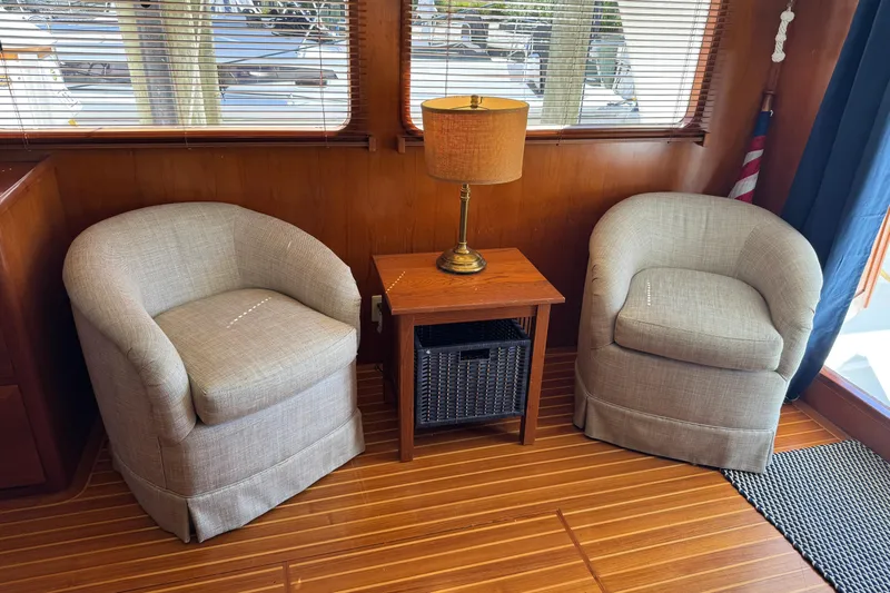 Marjorie Ann Yacht Photos Pics Interior of 2006 DeFever 52 Euro yacht with two armchairs and a lamp.