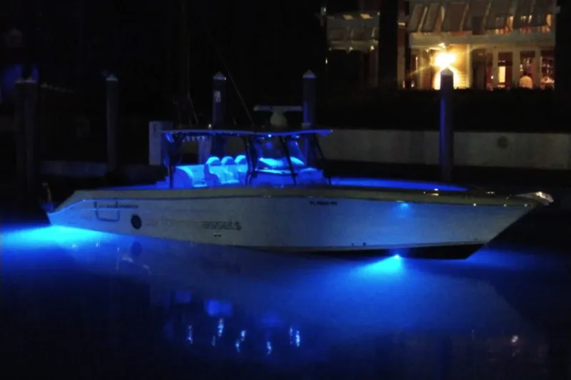 42 - Brokerage Higgins Yacht Photos Pics 2013 Hydra-Sports 42 boat illuminated with blue underwater lights at night.