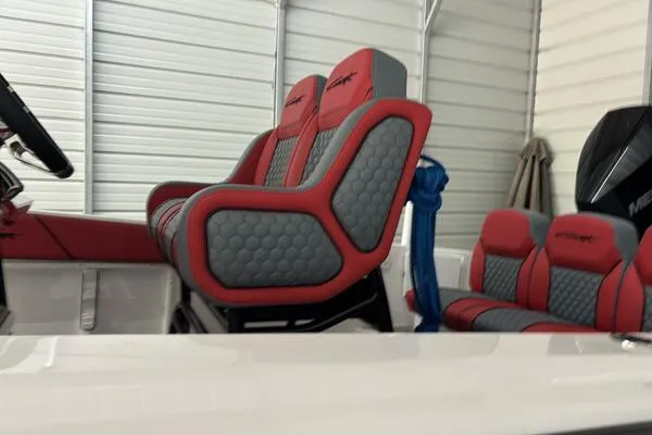  Yacht Photos Pics 2025 Concept 27' Open Deck boat with red and gray seating in a garage.