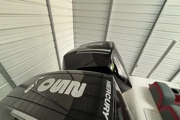  Yacht Photos Pics 2025 Concept 27' Open Deck boat with Mercury engines in a metal-roofed storage facility.