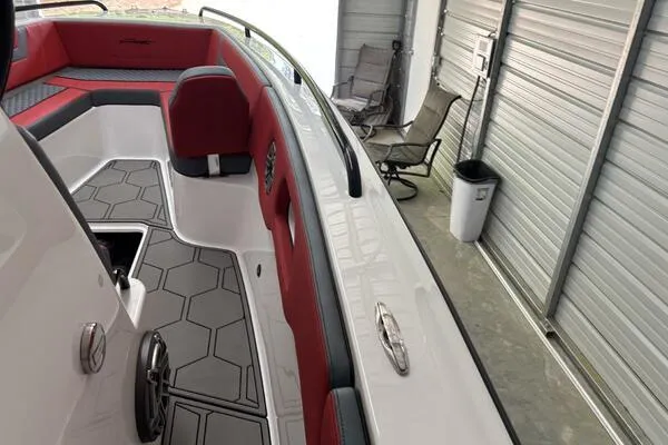 Yacht Photos Pics 2025 Concept 27' Open Deck boat with red and gray interior in a garage.