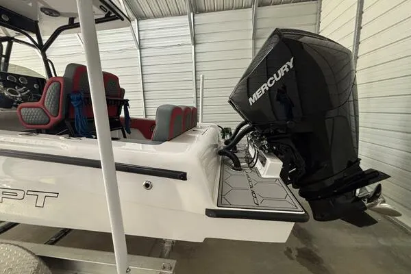  Yacht Photos Pics 2025 Concept 27' Open Deck boat with Mercury engine in storage facility.