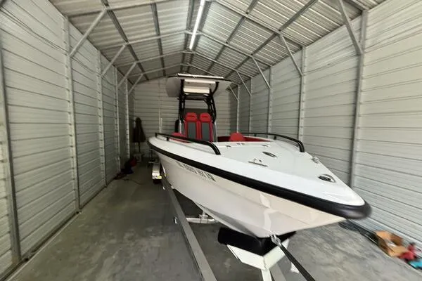  Yacht Photos Pics 2025 Concept 27' Open Deck boat in a metal storage shed.