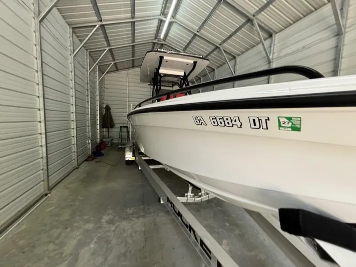  Yacht Photos Pics 2025 Concept 27' Open Deck boat in metal storage shed on trailer.