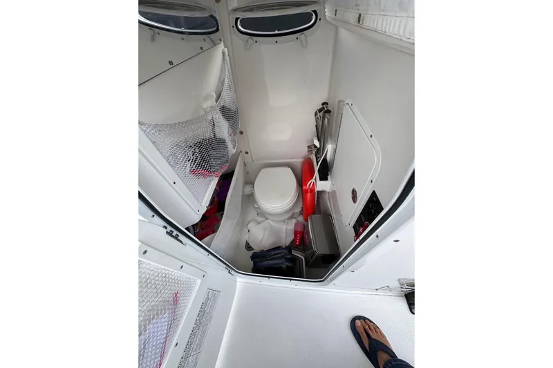  Yacht Photos Pics 2023 Sea Hunt Gamefish 27 boat interior with compact marine toilet and storage.