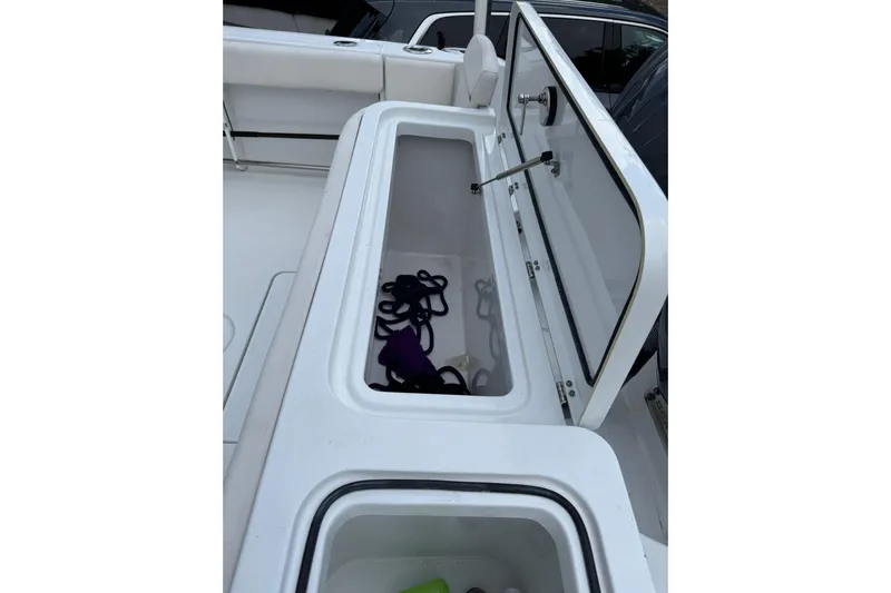  Yacht Photos Pics 2023 Sea Hunt Gamefish 27 storage compartment with open lid, showcasing interior space.