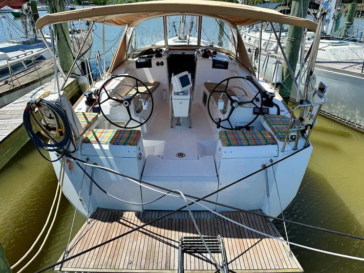 Celtic Rose Yacht Photos Pics 2018 Jeanneau Sun Odyssey 419 sailboat with dual steering wheels, docked at a marina.