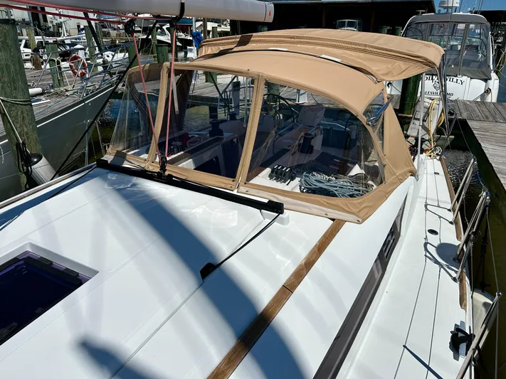 Celtic Rose Yacht Photos Pics 2018 Jeanneau Sun Odyssey 419 sailboat with tan canopy docked at marina.