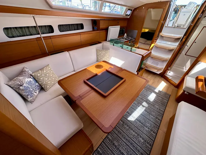 Celtic Rose Yacht Photos Pics Interior of 2018 Jeanneau Sun Odyssey 419 yacht with elegant seating and wooden finishes.