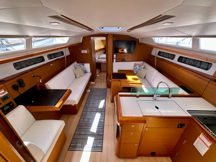 Celtic Rose Yacht Photos Pics 2018 Jeanneau Sun Odyssey 419 interior with modern design, spacious seating, and elegant wood finishes.