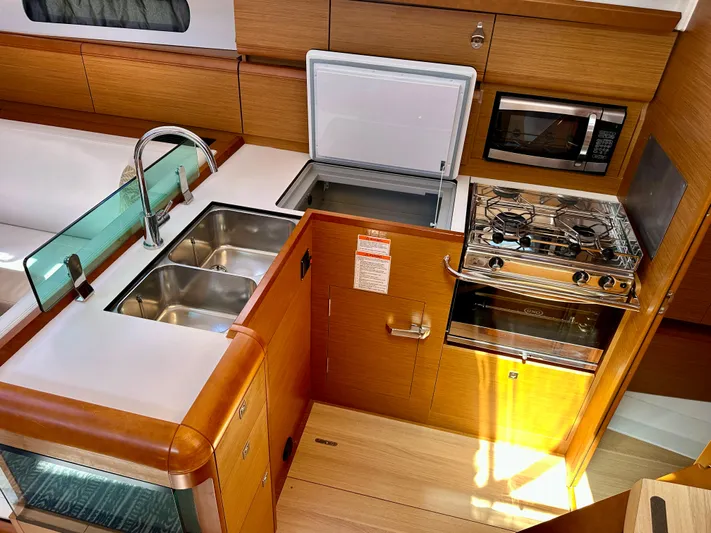 Celtic Rose Yacht Photos Pics 2018 Jeanneau Sun Odyssey 419 yacht kitchen with sink, stove, fridge, and microwave.