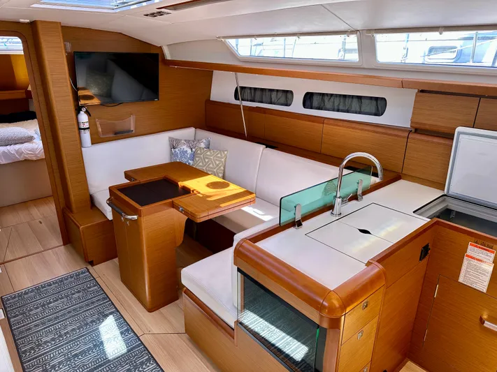 Celtic Rose Yacht Photos Pics 2018 Jeanneau Sun Odyssey 419 interior with modern kitchen, seating area, and TV.