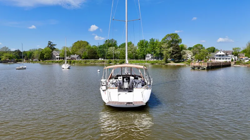 Celtic Rose Yacht Photos Pics 2018 Jeanneau Sun Odyssey 419 sailboat on calm water near a scenic shoreline.