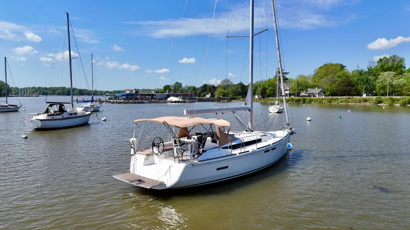 Celtic Rose Yacht Photos Pics 2018 Jeanneau Sun Odyssey 419 sailboat anchored in a serene harbor.