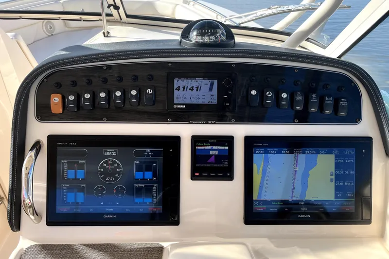 Liquid Carr-ma Yacht Photos Pics Control panel of 2017 Grady-White Freedom 307 boat with Garmin navigation displays.