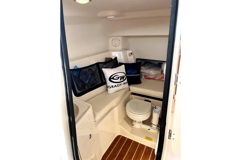 Liquid Carr-ma Yacht Photos Pics 2017 Grady-White Freedom 307 boat interior with toilet and seating area.