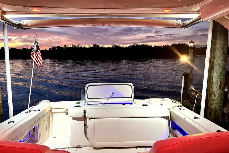 Liquid Carr-ma Yacht Photos Pics 2017 Grady-White Freedom 307 boat at sunset, docked with American flag.