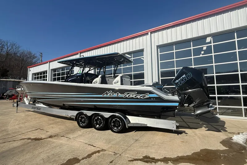  Yacht Photos Pics 2023 Nor-Tech 390 Sport Center Console boat on trailer outside a garage.