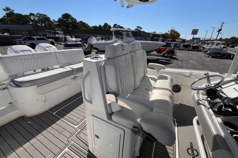  Yacht Photos Pics 2019 Fountain 38 Center Console boat interior with white seating and steering wheel.