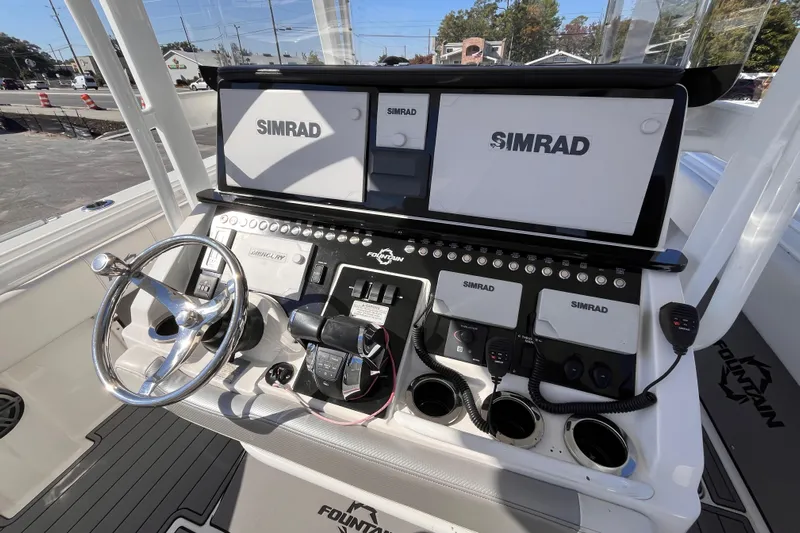  Yacht Photos Pics 2019 Fountain 38 Center Console boat dashboard with Simrad displays and steering wheel.