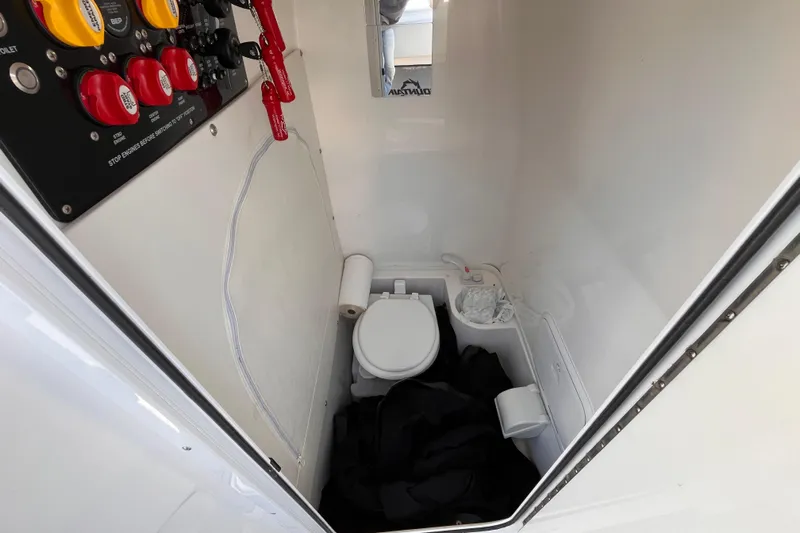  Yacht Photos Pics Interior of a 2019 Fountain 38 Center Console boat with a compact bathroom setup.