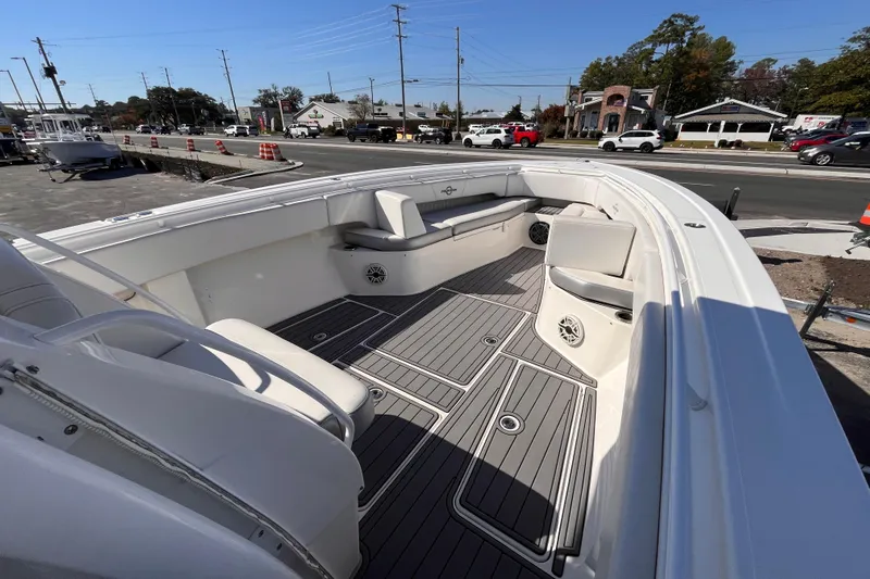  Yacht Photos Pics 2019 Fountain 38 Center Console boat with spacious deck and seating, parked near a road.