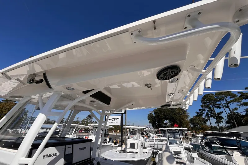  Yacht Photos Pics 2019 Fountain 38 Center Console boat with T-top and Simrad electronics, docked under clear blue sky.