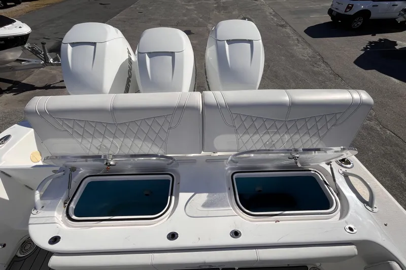  Yacht Photos Pics 2019 Fountain 38 Center Console boat with triple outboard engines and open storage compartments.