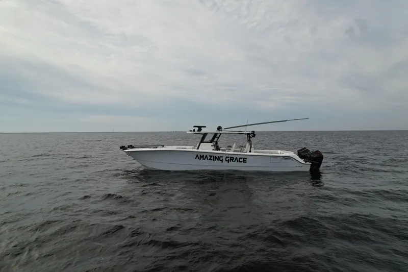 Amazing Grace Yacht Photos Pics 2022 Invincible 46 Catamaran "Amazing Grace" on open water under cloudy sky.