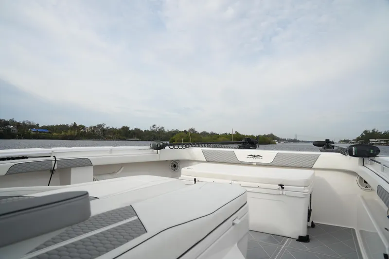 Amazing Grace Yacht Photos Pics 2022 Invincible 46 Catamaran interior with seating and storage, cruising on a calm waterway.