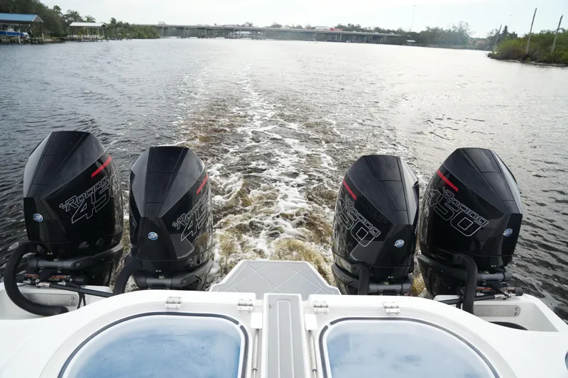 Amazing Grace Yacht Photos Pics 2022 Invincible 46 Catamaran with quad outboard engines cruising on a river.