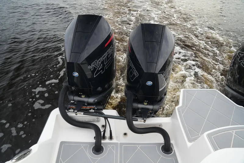 Amazing Grace Yacht Photos Pics Twin outboard engines on 2022 Invincible 46 Catamaran, cruising on water.
