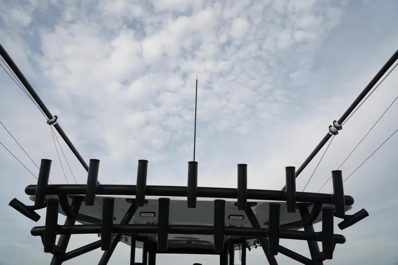 Amazing Grace Yacht Photos Pics Invincible 46 Catamaran 2022, fishing rod holders against cloudy sky.