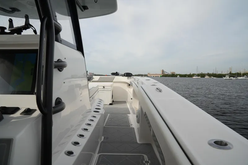 Amazing Grace Yacht Photos Pics 2022 Invincible 46 Catamaran on water, showcasing sleek deck design and spacious layout.