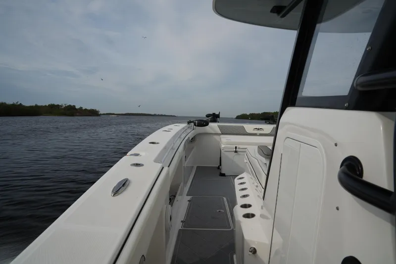 Amazing Grace Yacht Photos Pics 2022 Invincible 46 Catamaran on calm waters, showcasing sleek design and spacious deck.