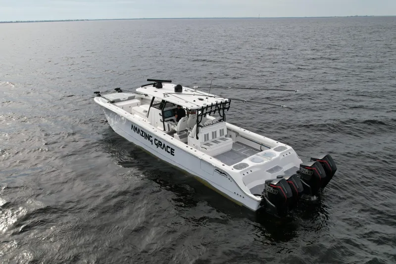 Amazing Grace Yacht Photos Pics Invincible 46 Catamaran 2022 on open water, featuring triple outboard engines.